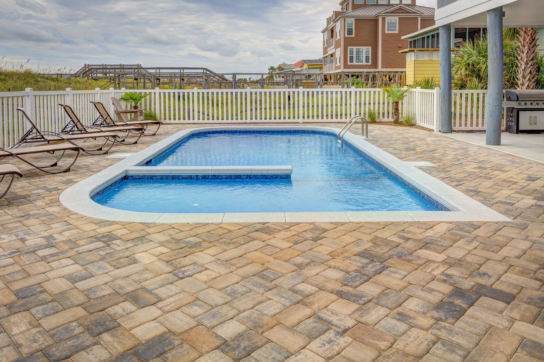 Pool with paver patio and deck area